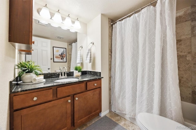 full bathroom featuring vanity, shower / tub combo, and toilet