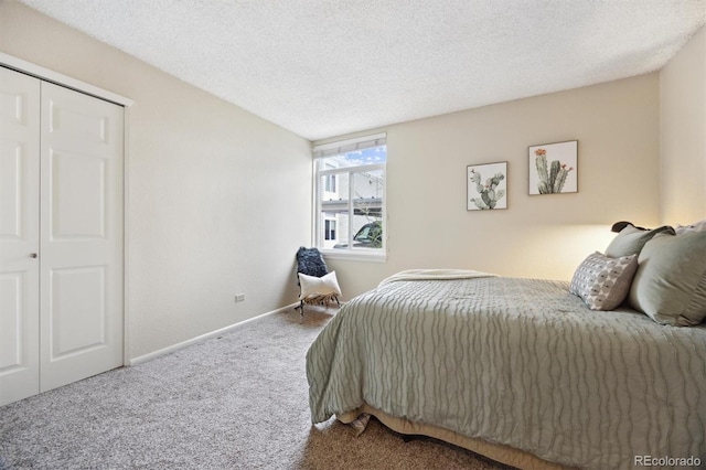 bedroom with a closet, a textured ceiling, and carpet