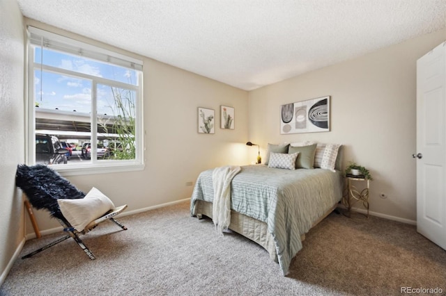 bedroom with carpet floors and a textured ceiling