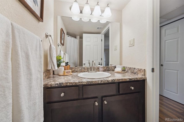 bathroom with vanity and wood-type flooring