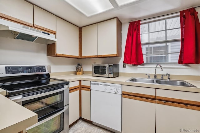 kitchen featuring sink, white cabinets, and appliances with stainless steel finishes