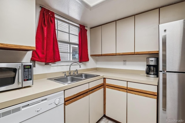 kitchen featuring sink, stainless steel appliances, and white cabinets