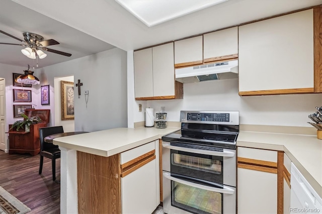 kitchen featuring dishwasher, white cabinets, hardwood / wood-style flooring, double oven range, and kitchen peninsula