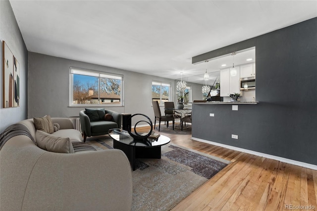 living room with baseboards and hardwood / wood-style flooring