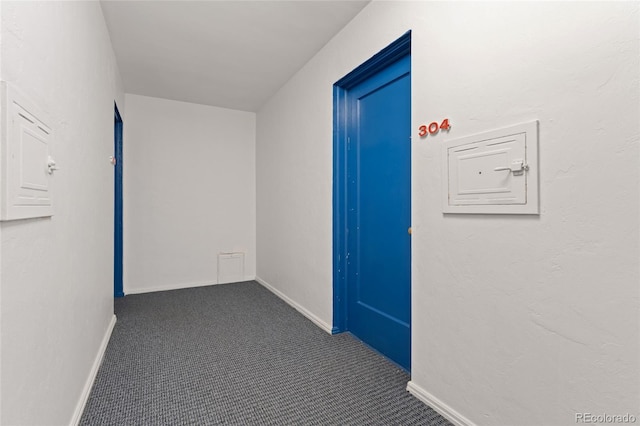 hallway with carpet flooring and baseboards