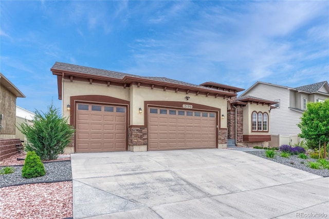 13190 Stone Peaks Way, Peyton, CO 80831 - mediterranean / spanish house featuring stucco siding, an attached garage, concrete driveway, and stone siding