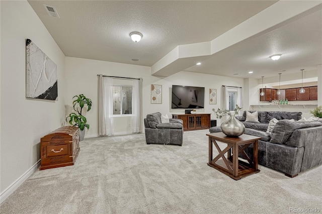 13190 Stone Peaks Way, Peyton, CO 80831 - carpeted living room featuring a textured ceiling and baseboards