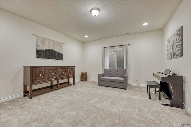 13190 Stone Peaks Way, Peyton, CO 80831 - living area featuring carpet flooring, recessed lighting, and a textured ceiling