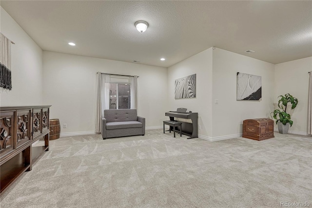 13190 Stone Peaks Way, Peyton, CO 80831 - sitting room with a textured ceiling, light carpet, and recessed lighting