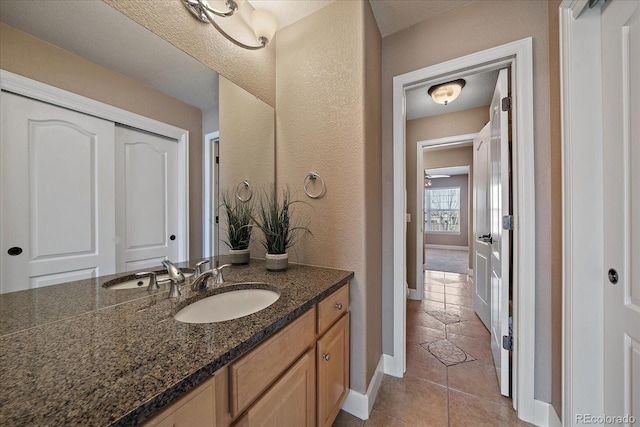 bathroom featuring vanity, a textured ceiling, and tile patterned flooring