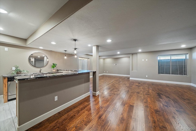 interior space with wood-type flooring and a textured ceiling