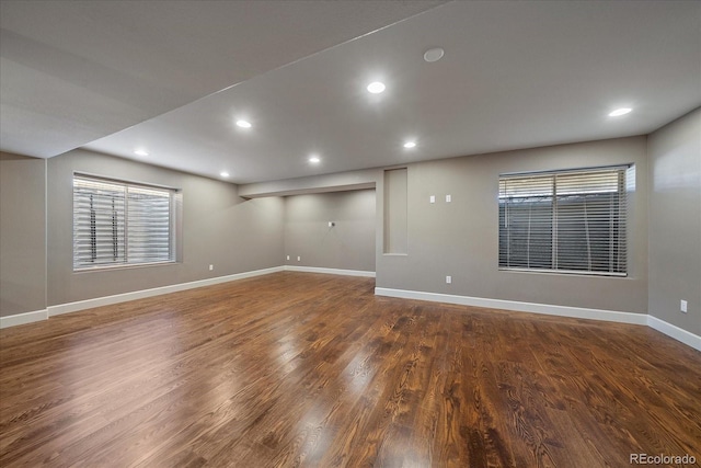 unfurnished room with dark wood-type flooring