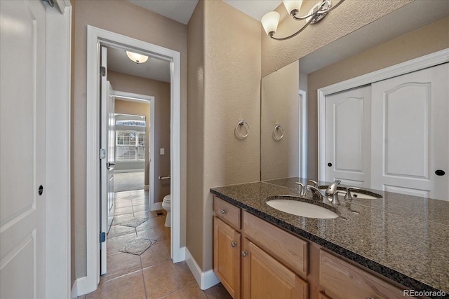 bathroom featuring vanity, toilet, and tile patterned flooring