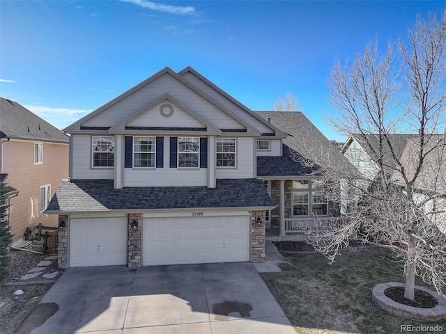 view of front of house with concrete driveway, a garage, stone siding, and a shingled roof