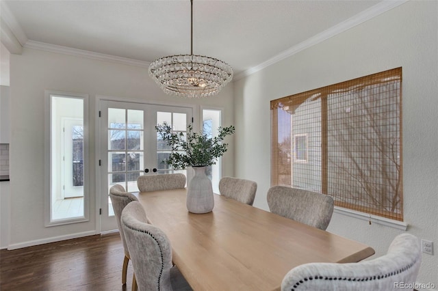 dining space featuring a notable chandelier, crown molding, baseboards, and dark wood-style flooring