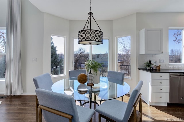 dining area with dark wood-style floors and baseboards