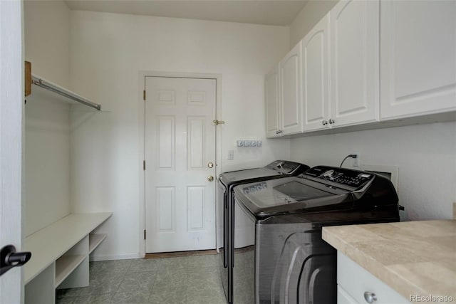 clothes washing area with cabinet space, baseboards, and separate washer and dryer