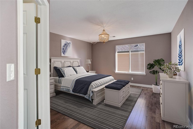 22388 Quail Run Dr, Parker, CO 80138 - bedroom with dark wood finished floors, baseboards, and a chandelier