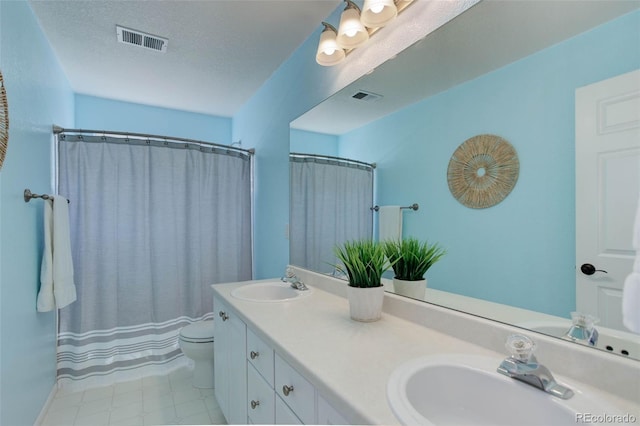 22388 Quail Run Dr, Parker, CO 80138 - bathroom with double vanity, toilet, and a textured ceiling