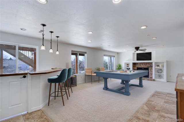 22388 Quail Run Dr, Parker, CO 80138 - playroom featuring light carpet, a fireplace, a ceiling fan, recessed lighting, and baseboards
