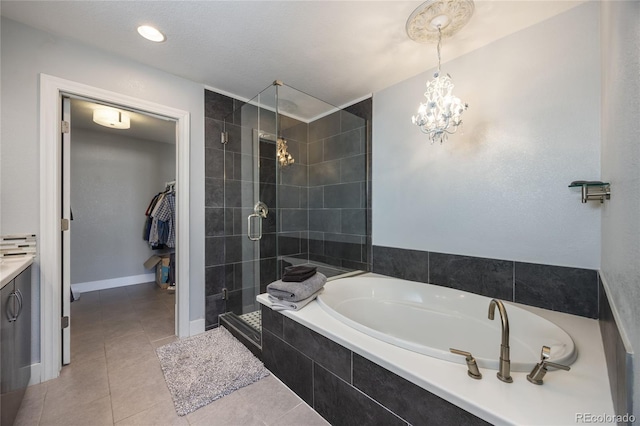 full bathroom with baseboards, tile patterned floors, a garden tub, a shower stall, and a notable chandelier