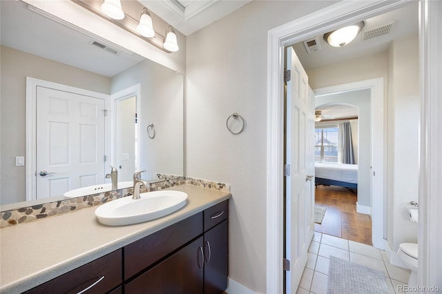 bathroom featuring toilet, vanity, visible vents, and tile patterned floors