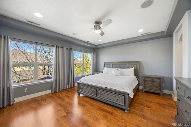 bedroom with ceiling fan, recessed lighting, wood finished floors, visible vents, and baseboards