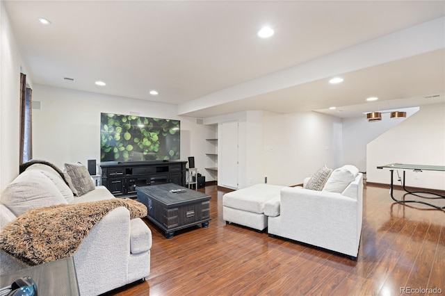 living area featuring visible vents, baseboards, wood finished floors, and recessed lighting