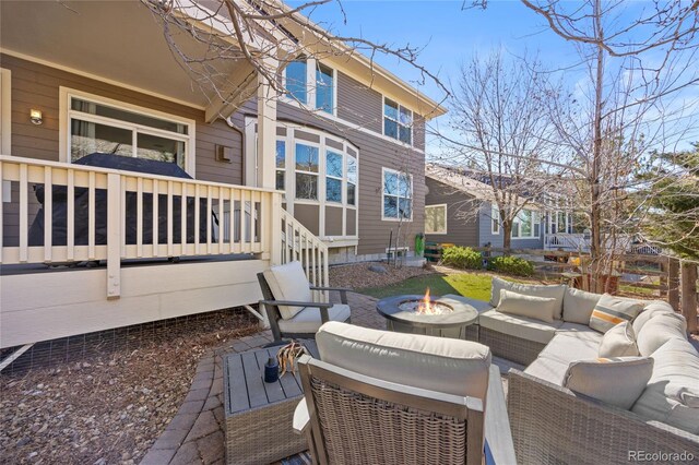 exterior space with a deck and an outdoor living space with a fire pit