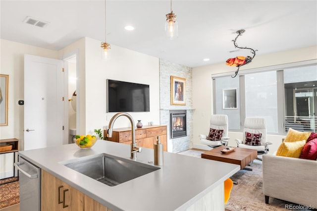 1333 Elati St Unit 1, Denver, CO 80204 - kitchen with open floor plan, a large fireplace, a sink, and a center island with sink