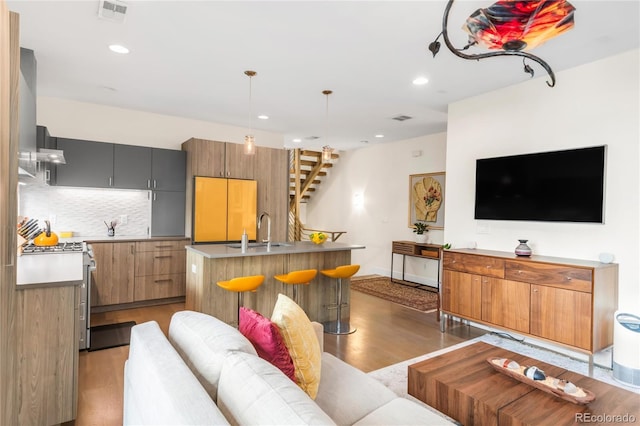 1333 Elati St Unit 1, Denver, CO 80204 - living area with recessed lighting, baseboards, visible vents, and light wood-style floors