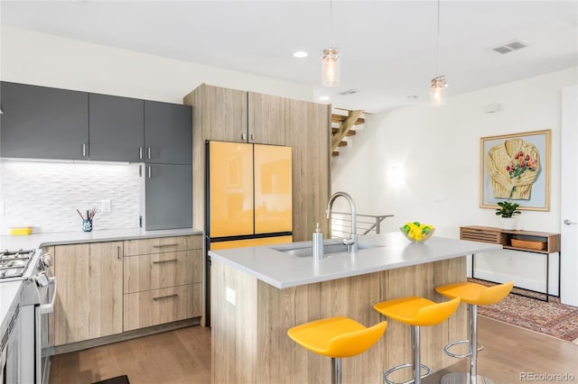 1333 Elati St Unit 1, Denver, CO 80204 - kitchen featuring stainless steel range with gas stovetop, visible vents, a sink, and light wood-style flooring