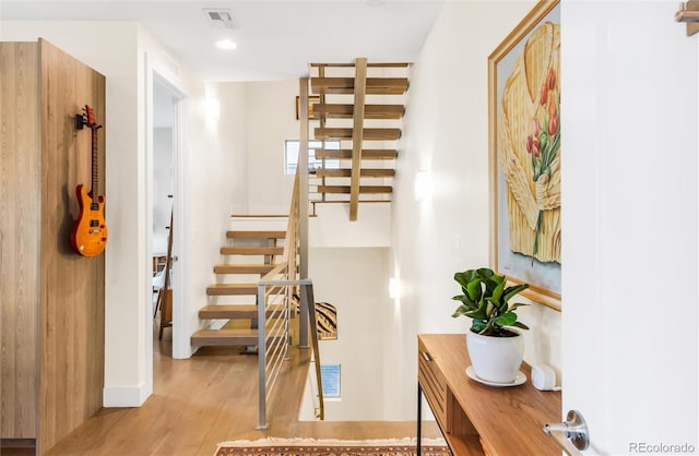 1333 Elati St Unit 1, Denver, CO 80204 - stairway featuring visible vents, baseboards, and wood finished floors