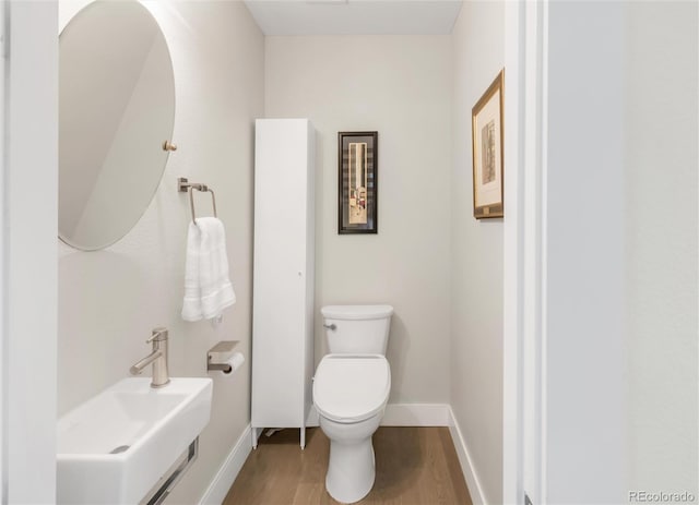 1333 Elati St Unit 1, Denver, CO 80204 - bathroom with baseboards, wood finished floors, and toilet