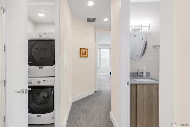 1333 Elati St Unit 1, Denver, CO 80204 - laundry room with visible vents, stacked washer and clothes dryer, carpet floors, baseboards, and a sink