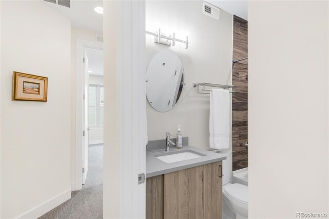 1333 Elati St Unit 1, Denver, CO 80204 - bathroom featuring vanity, baseboards, toilet, and visible vents