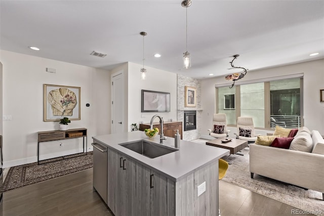 1333 Elati St Unit 1, Denver, CO 80204 - kitchen with open floor plan, recessed lighting, dark wood-style flooring, a large fireplace, and dishwasher