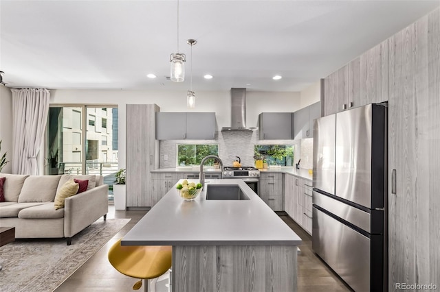 1333 Elati St Unit 1, Denver, CO 80204 - kitchen featuring appliances with stainless steel finishes, wall chimney exhaust hood, gray cabinets, modern cabinets, and recessed lighting
