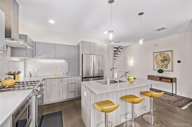 1333 Elati St Unit 1, Denver, CO 80204 - kitchen with stainless steel appliances, wall chimney exhaust hood, modern cabinets, dark wood-type flooring, and recessed lighting