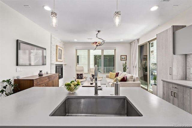 1333 Elati St Unit 1, Denver, CO 80204 - kitchen featuring open floor plan, light countertops, a fireplace, pendant lighting, and recessed lighting