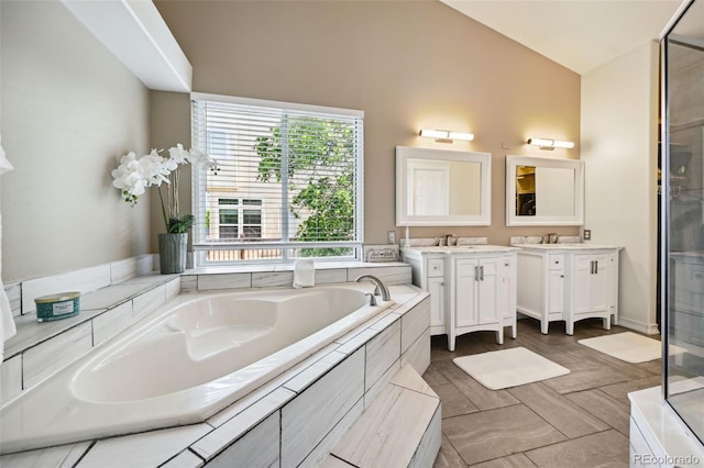 5465 Broadmoor Bliff Dr, Colorado Springs, CO 80904 - bathroom with vanity, a garden tub, a stall shower, and vaulted ceiling