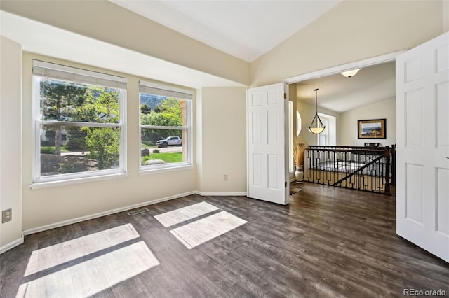 5465 Broadmoor Bliff Dr, Colorado Springs, CO 80904 - spare room featuring vaulted ceiling, dark wood-style floors, and baseboards
