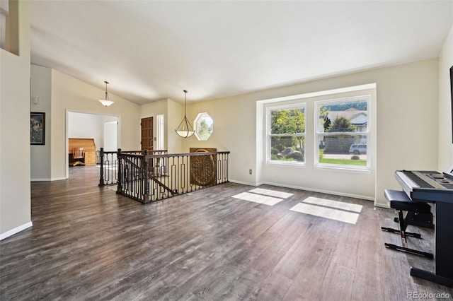 5465 Broadmoor Bliff Dr, Colorado Springs, CO 80904 - empty room featuring dark wood-style flooring, vaulted ceiling, and baseboards