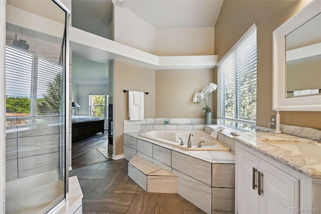 5465 Broadmoor Bliff Dr, Colorado Springs, CO 80904 - full bathroom with a bath, a stall shower, vanity, baseboards, and connected bathroom