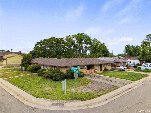 5671 E 60th St, Commerce City, CO 80022 - ranch-style house featuring a front yard and solar panels