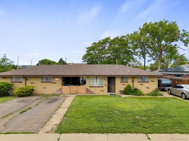 5671 E 60th St, Commerce City, CO 80022 - ranch-style house with a front lawn, brick siding, and roof with shingles
