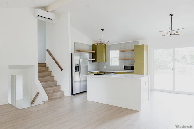 kitchen featuring a center island, a wall mounted AC, hanging light fixtures, a notable chandelier, and stainless steel appliances