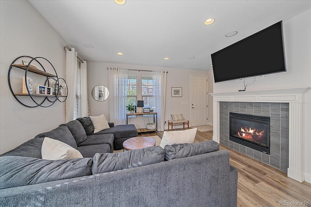 21392 E Stroll Ave, Parker, CO 80138 - living room with light wood-style flooring, recessed lighting, and a tiled fireplace