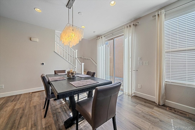 21392 E Stroll Ave, Parker, CO 80138 - dining room with stairs, a chandelier, wood finished floors, recessed lighting, and healthy amount of natural light