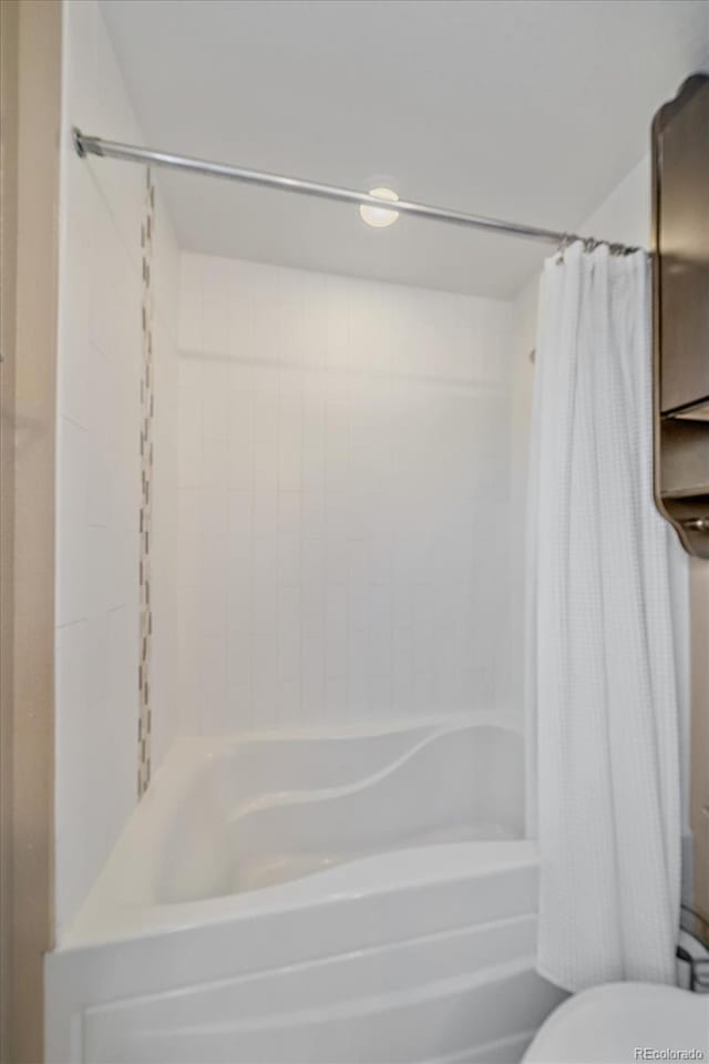 21392 E Stroll Ave, Parker, CO 80138 - bathroom with shower / tub combo with curtain and toilet